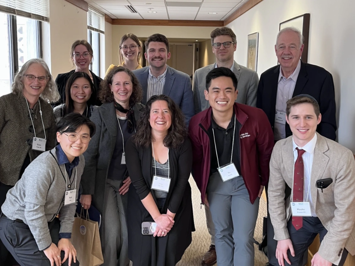 team of doctors putting hands in ready to cheer and get to work