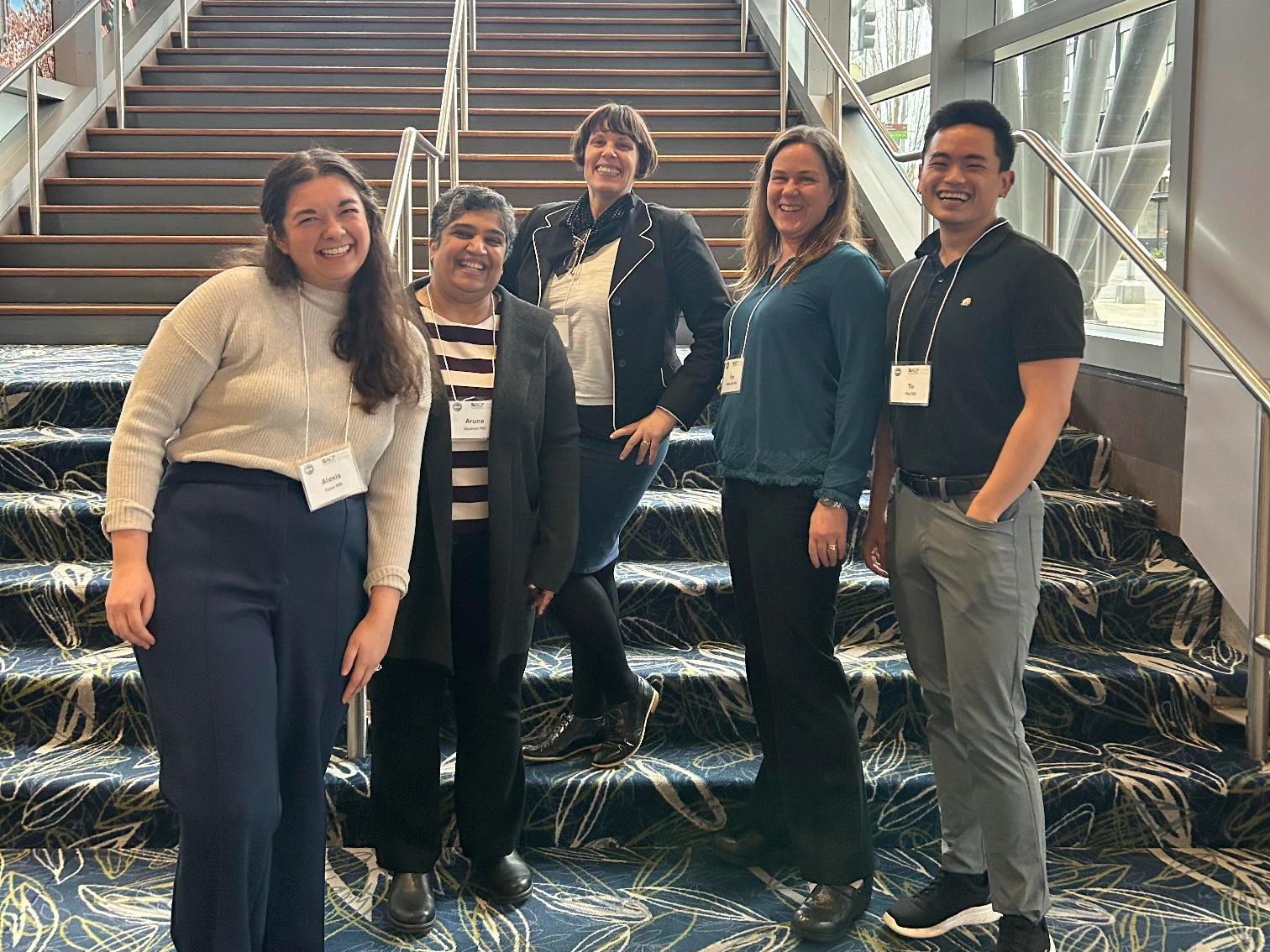 team of doctors putting hands in ready to cheer and get to work